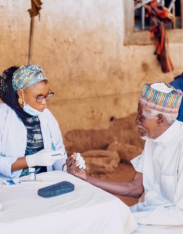 Healthcare workers assisting a community member